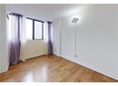 Spare room featuring light wood finished floors and baseboards