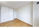 Unfurnished bedroom with light wood-style floors, a closet, and baseboards