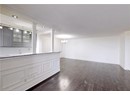 Bar area featuring dark wood-style floors, a chandelier, ornamental molding, tasteful backsplash, and pendant lighting
