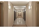 Corridor with baseboards and light tile patterned flooring