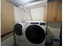 Washroom with cabinet space and washer and dryer