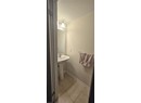 Bathroom featuring tile patterned flooring, baseboards, and a sink