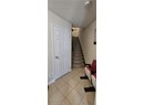 Stairway featuring tile patterned floors, a textured ceiling, and baseboards