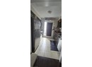 Kitchen with appliances with stainless steel finishes, light tile patterned flooring, and a sink