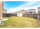 View of yard with an outbuilding, a residential view, a fenced backyard, and a shed
