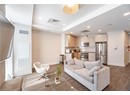 Living area featuring wood finished floors, visible vents, and baseboards