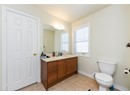 Bathroom featuring vanity, baseboards, toilet, and tile patterned flooring