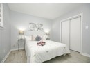 Bedroom with baseboards, a closet, and light wood-style floors