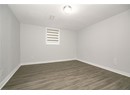 Unfurnished room with visible vents, dark wood-style floors, baseboards, and a textured ceiling