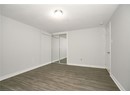 Unfurnished bedroom with dark wood-style floors, a closet, baseboards, and a textured ceiling