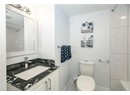 Full bath featuring baseboards, toilet, a shower, and vanity