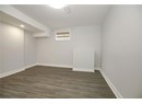 Basement with dark wood-style floors, baseboards, and recessed lighting