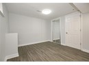Unfurnished bedroom featuring baseboards, dark wood-style flooring, visible vents, and a closet