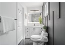 Full bath featuring a stall shower, vanity, and toilet