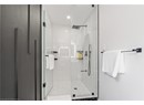 Bathroom featuring a shower stall and recessed lighting