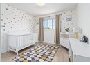 Bedroom with light wood-style floors and baseboards