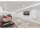 Living area with light wood-style flooring, recessed lighting, and baseboards