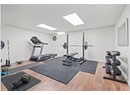 Workout room with wood finished floors, baseboards, and a drop ceiling