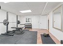 Workout area with a drop ceiling, baseboards, and wood finished floors