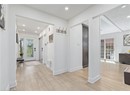 Foyer featuring light wood-style floors, recessed lighting, baseboards, and ornate columns