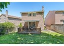 Rear view of property featuring brick siding and a patio