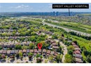 Aerial view of property's location with a main thoroughfare, nearby suburban area, and nearby urban area