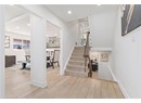 Stairs with wood finished floors, baseboards, and recessed lighting