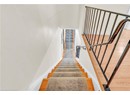 Staircase with baseboards and wood finished floors