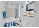 Full bath featuring vanity, tile patterned flooring, shower / bath combo with shower curtain, and toilet