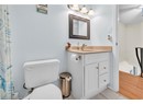 Full bathroom featuring toilet, vanity, and tile patterned flooring