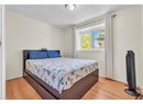 Bedroom with wood finished floors, baseboards, and a textured ceiling