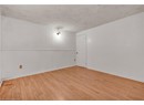 Spare room featuring a textured ceiling, wood finished floors, and baseboards