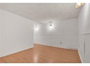 Unfurnished room featuring a textured ceiling, light wood-style floors, and baseboards