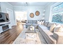 Living room featuring hardwood / wood-style floors, ceiling fan, and crown molding