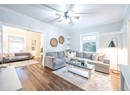 Living room with wood-type flooring and crown molding