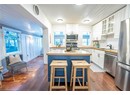 Kitchen with sink, stainless steel appliances, wood counters, a kitchen bar, and white cabinets