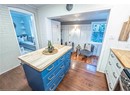 Bathroom with hardwood / wood-style flooring, crown molding, and wooden walls