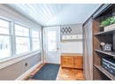 Mudroom with wood ceiling, a barn door, light hardwood / wood-style floors, and vaulted ceiling