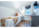 Bedroom featuring dark wood-type flooring and vaulted ceiling