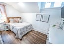 Bedroom featuring dark hardwood / wood-style flooring and vaulted ceiling