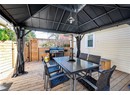Deck with outdoor dining area, fence, and a grill