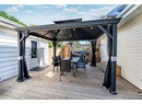 Wooden deck featuring a gazebo, outdoor dining space, and fence