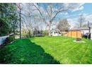 View of yard with a trampoline, a storage shed, an outdoor fire pit, and an outdoor structure