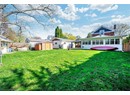 Back of house featuring a storage shed, a gazebo, a chimney, an outbuilding, and a patio area
