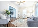 Living room with dark hardwood / wood-style floors, ceiling fan, and ornamental molding