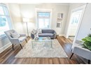 Living room with dark hardwood / wood-style floors and ornamental molding