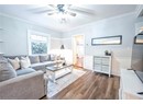 Living room with crown molding, ceiling fan, and dark hardwood / wood-style floors
