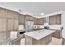 Kitchen with tasteful backsplash, sink, a kitchen island with sink, stainless steel appliances, and wall chimney exhaust hood