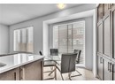 Dining space with light tile patterned flooring
