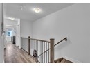 Hallway with light hardwood / wood-style floors and a textured ceiling